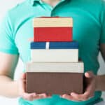 closeup guy holding stacked gift boxes